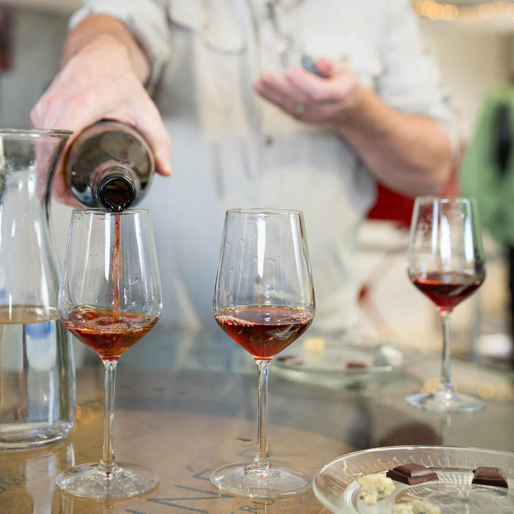 sommelier pouring strawberry wine