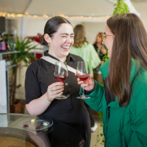 women sharing a glass of wine
